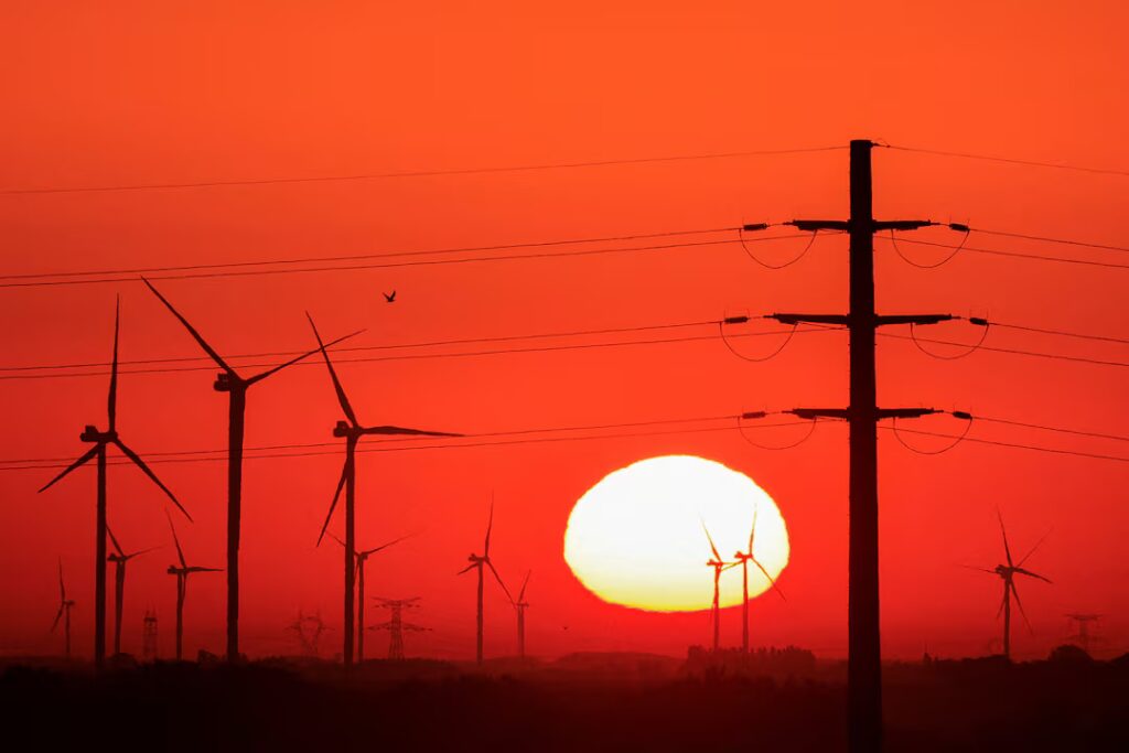Source: Power-generating windmill turbines and electricity pylons are pictured during sunrise at a wind park in Avesnes-le-Sec, France, September 8, 2023. REUTERS, Pascal Rossignol